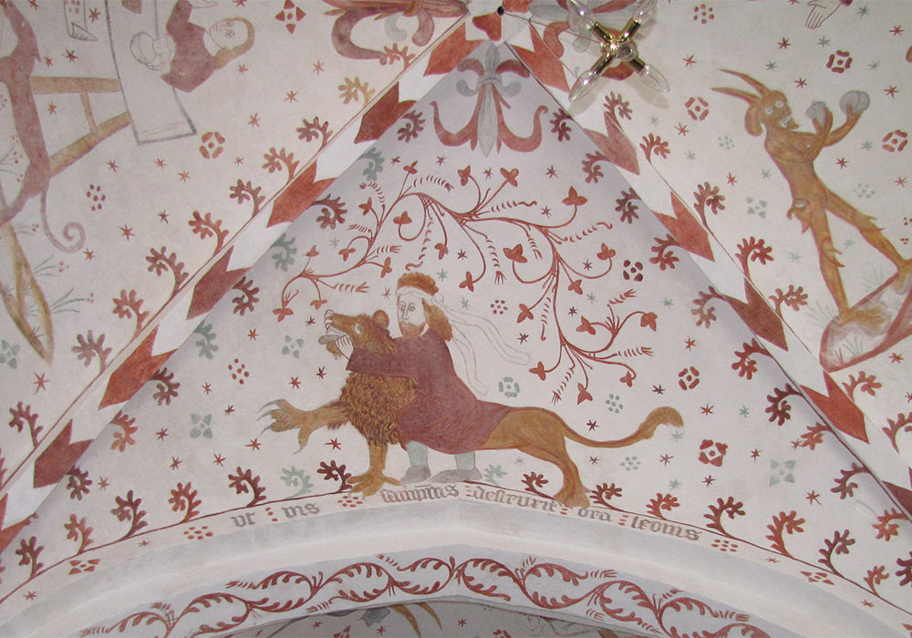 Samson dreper løven, et typologisk forbilde for Kristi nedstigning i dødsriket. Kalkmaleri i Fanefjord kirke i Danmark laget av Elmelundverkstedet ca. 1500–20